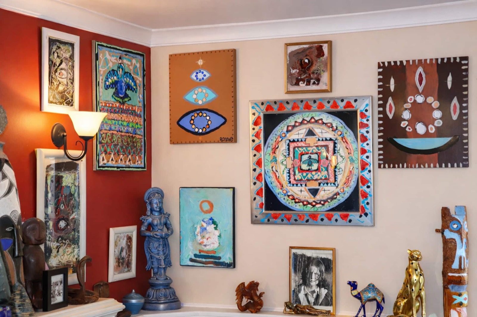 A wall of the artist's paintings and collected pieces
