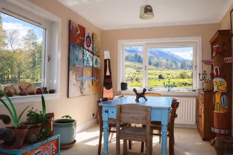 The dining room, windows on two sides looking out to the hills