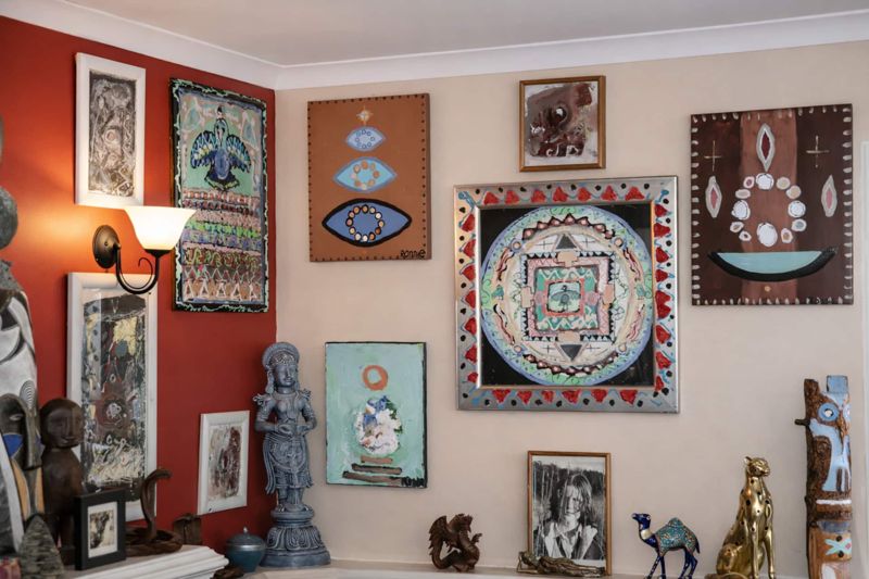 A wall of the artist's own paintings and collected pieces