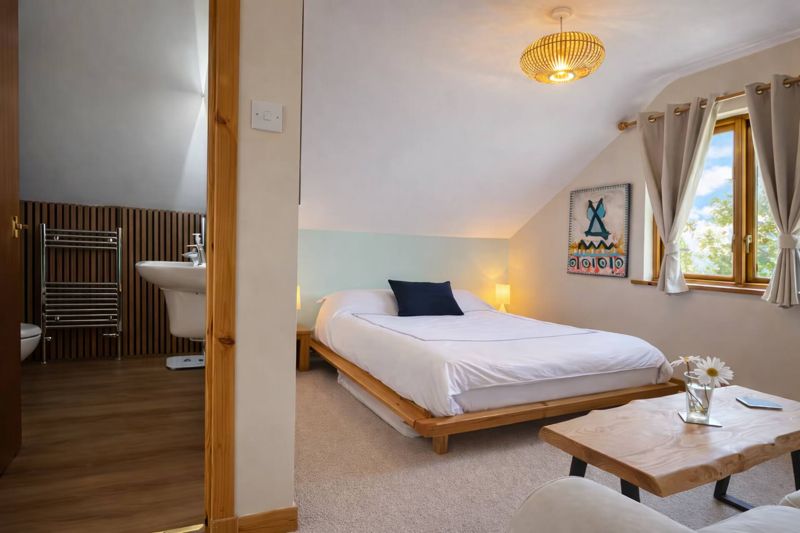 A bedroom with its en-suite bath just beyond