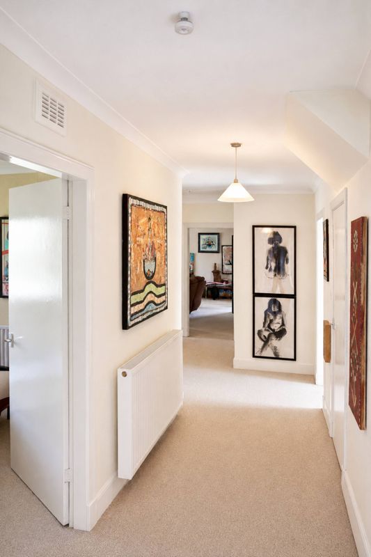 The hallway, hung with art from end to end